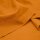 Das Bild zeigt den Heavy Washed Canvasstoff in carrot. Es ist ein helles orange. Der Stoff liegt leicht aufgefaechert auf einem Tisch.