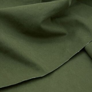 Das Bild zeigt den Heavy Washed Canvasstoff in Khaki gruen. Es ist ein khaki gruen. Der Stoff liegt leicht aufgefaechert auf einem Tisch.